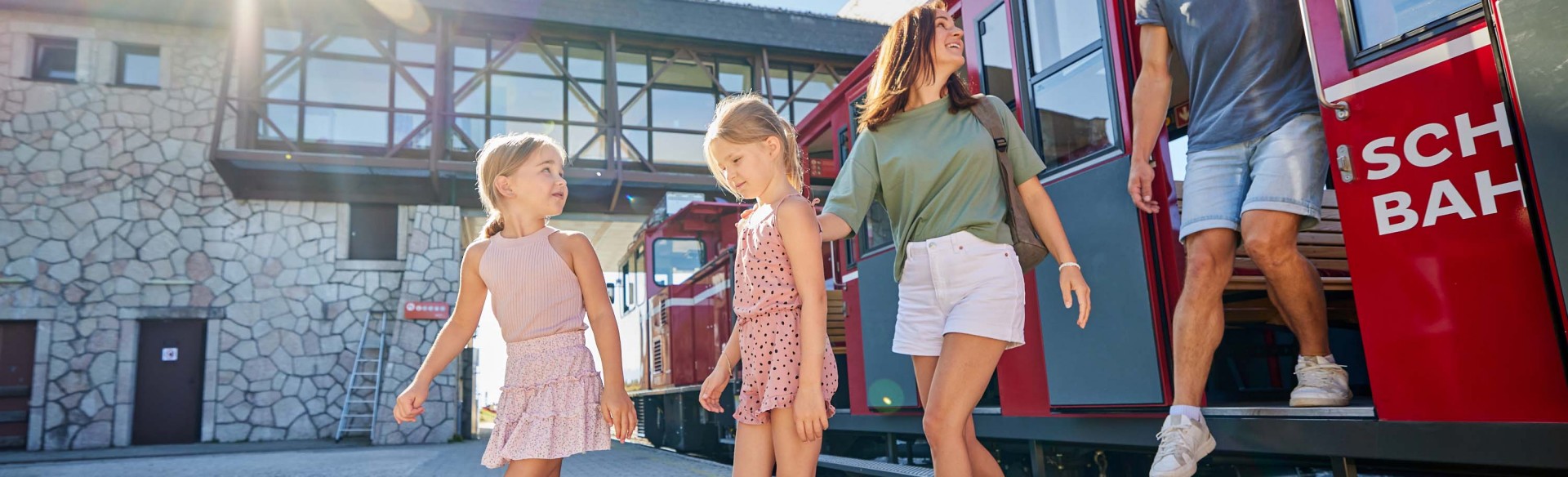 Eine Familie steigt am Gipfel aus der SchafbergBahn aus. 